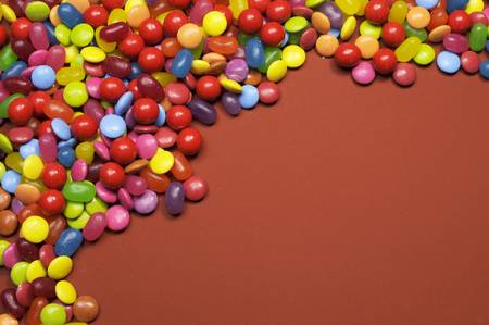 Bright colorful background abstract of multi-colored candy lollies and sweets for Halloween or Christmas or children party, with copy space for your text here.の写真素材