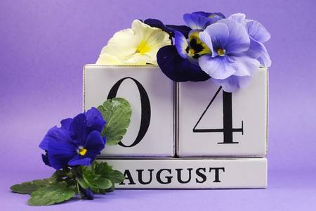 Save the Date white block calendar for August 4, International Friendship Day, decorated with blue and white pansy violas on blue purple background の写真素材