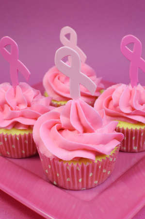 Pink cupcakes with Pink Ribbon symbol for International Breast Cancer Awareness charity month of October. Vertical.の写真素材
