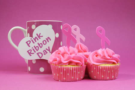 Pink cupcakes with Pink Ribbon symbol for International Breast Cancer Awareness charity month of October, with Pink Ribbon Day message on polka dot cup.
