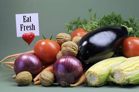 Eat Fresh message sign with fresh raw vegetarain food including eggplant, onion, corn, tomatoes,...
