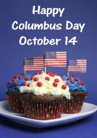 Happy Columbus Day for October 14 message and Red, White and Blue chocolate cupcakes with USA Stars   Stripes flags on blue background の写真素材