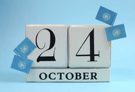 Save the Date white block calendar for October 24, United Nations Day, with the United Nations sky blue flags, against a sky blue background の写真素材