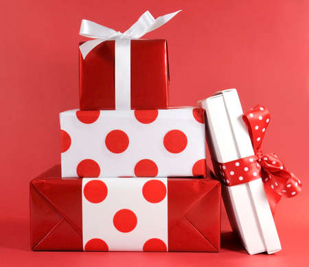 Stack of red and white polka dot theme festive gift box presents for Christmas, Valentine, birthday or Mothers Day occasion.の写真素材