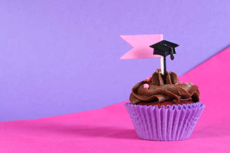 Graduation day pink and purple party cupcake on pink and purple の写真素材