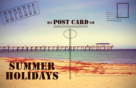 Retro vintage filter style old faded Summer Holidays Vacation postcard with jetty pier boardwalk on calm ocean beach.の写真素材