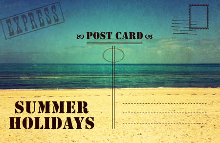Retro vintage filter style old faded Summer Holidays Vacation postcard with ocean beach scene and text.の写真素材