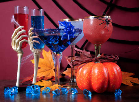 Happy Halloween ghoulish party cocktail drinks with spider web and decorations on purple background.の写真素材