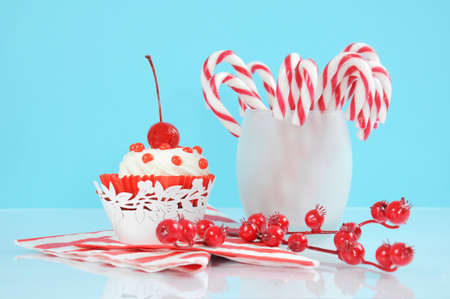 Christmas holiday dessert party candy canes with cupcake in modern red and white trend on pale blue...