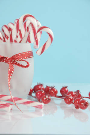 Christmas holiday dessert party candy canes in modern red and white trend on pale blue and white background. Vertical.の写真素材
