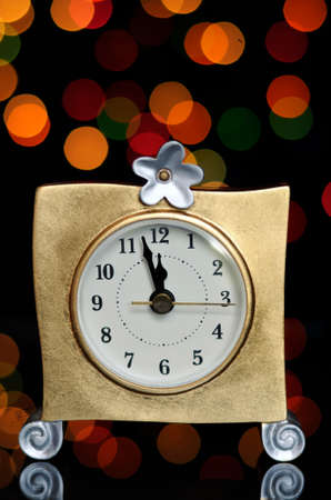 Happy New Year Eve party with ... on reflective table against bright color festive bokeh lights.