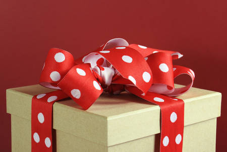 Natural modern trend gift wrapping with brown kraft gift box and red and white polka dot ribbon on...