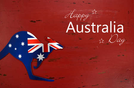 Australia Day background with kangaroo shape Australian flag on red rustic recycled wood background with sample text.の写真素材