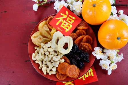 Happy Chinese New Year celebration party tray of togetherness on red wood background.の写真素材