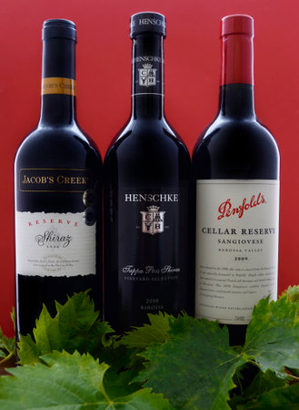 ADELAIDE, SOUTH AUSTRALIA â FEBRUARY 23, 2015: Selection of three bottles of premium export quality Australian wine, including Henschke Tappa Pass Shiraz, Penfolds Cellar Reserve Sangiovese and Jacobs Creek Reserve Shiraz vintage 1998, produced in the Bのeditorial素材