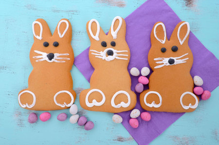 Easter bunny gingerbread cookies on blue distressed wood table.