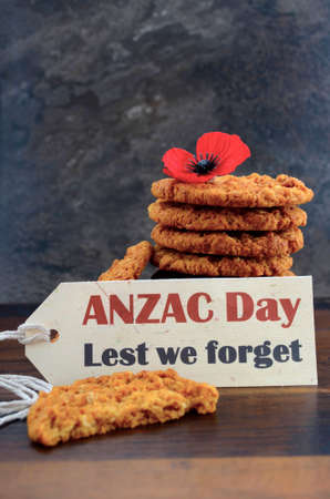 Australian Anzac biscuits with Anzac DAy, Lest We Forget message on dark wood and slate background.の写真素材