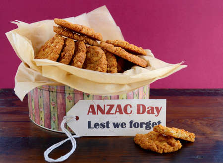 Australian Anzac biscuits in vintage biscuit tin container with Lest We Forget message.の写真素材