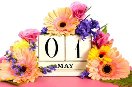 Happy May Day vintage wood calendar decorated with Spring flowers on pink wood table.の写真素材