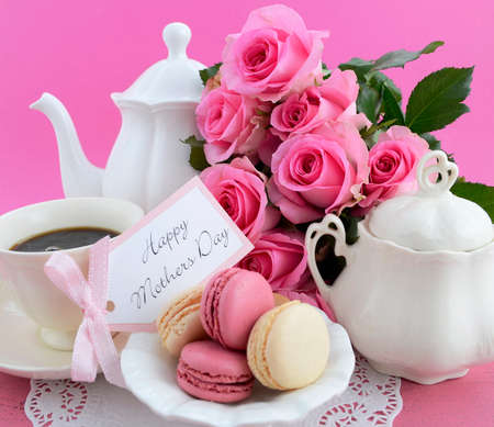 Happy Mothers Day Pink Roses and Tea Pot and tea setting on shabby chic style vintage distressed pink wood table. .の写真素材