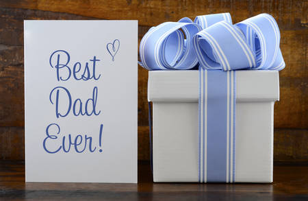 Happy Fathers Gift with blue and white gift on wood background, and Best Dad Ever greeting card.の写真素材