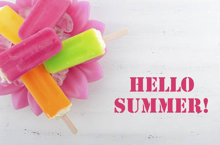 Summer is Here concept with bright color ice pop, ice creams with Hello Summer text.の写真素材