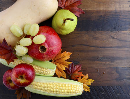 Autumn Fall harvest fruit and vegetables on dark vintage reclaimed wood for Thanksgiving, Halloween...