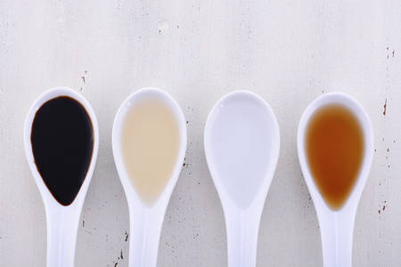 Serving size samples of different types of vinegar including Balsamic, Apple Cider, White and Malt vinegars.の写真素材