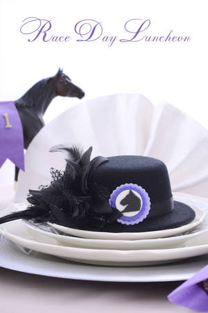 Horse racing Ladies Luncheon fine dining table setting with small black fascinator hat, decorations and champagne.の写真素材