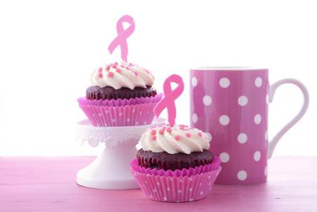 Host an Event for Pink Ribbon Day charity for womens breast cancer awareness with pink and red velvet cupcakes, with coffee and tea.の写真素材