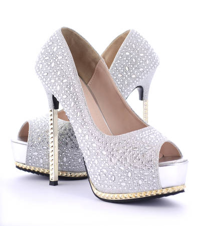 Pair of rhinestone high heel stiletto shoes on white background.の写真素材