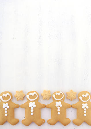Festive Christmas Happy Holidays background with decorated borders of gingerbread men and star...