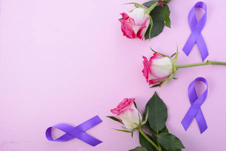 International Womens Day, March 8, flat lay arrangement of roses and purple ribbons on pink wood table background.の写真素材
