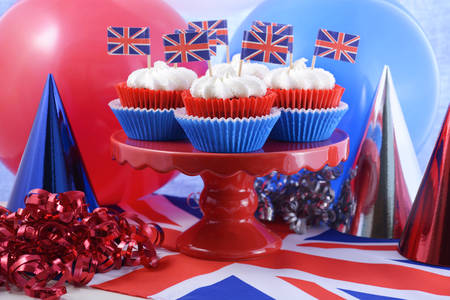 Holiday party cupcakes with UK flags and red, white and blue party hats and balloons.の写真素材