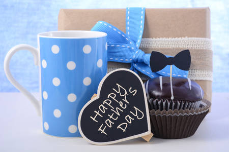 Happy Fathers Day cupcake gift on pale blue and white wood background.の写真素材
