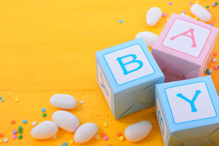 Baby Shower or Nursery background with decorated borders on a yellow wood background.の写真素材