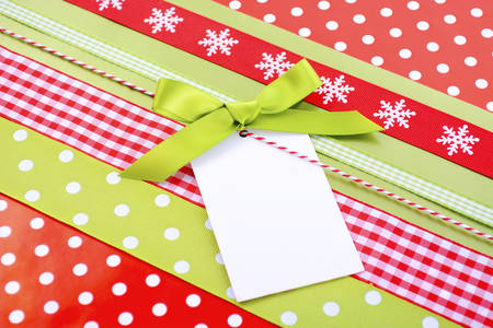 Modern Christmas holiday greeting background with bright red and avocado green gift wrapping with...