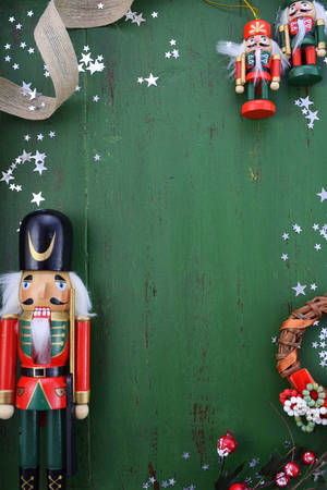 Happy Holidays Christmas background with copy space and borders decorated with ornaments on a rustic green wood background.の写真素材