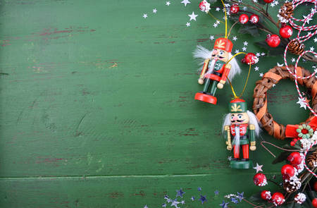 Happy Holidays Christmas background with copy space and borders decorated with ornaments on a rustic green wood background.の写真素材