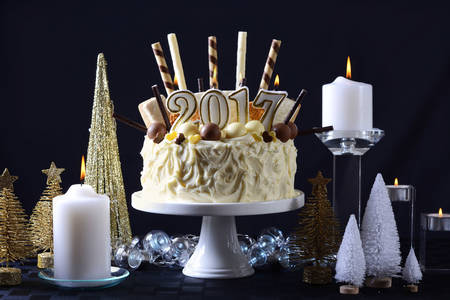 Festive holidays 2017 Happy New Year centerpiece white chocolate cake with candy and cookies...