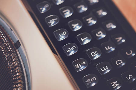 Macro closeup of typewriter keys and keyboard, with applied retro vintage  style filters.の写真素材