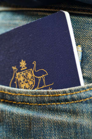 Australian passport in mans jeans pocket, close up vertical.の写真素材