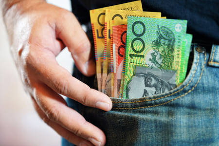 Australian cash money in mans jeans pocket, close up.の写真素材