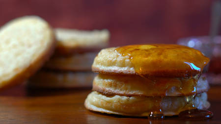 Hot Australian English style breakfast crumpets macro closeup, with honey dripping over the side.の写真素材