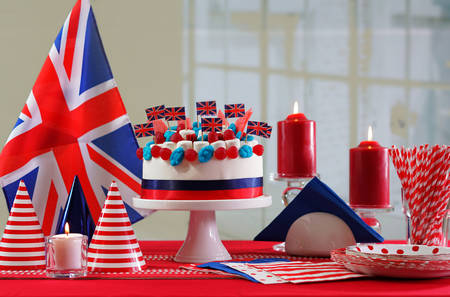 UK National holiday celebration party table with showstopper cake and flags.の写真素材
