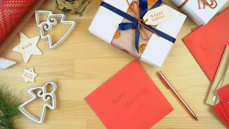 Wrapping gifts and writing Christmas cards overhead.の写真素材