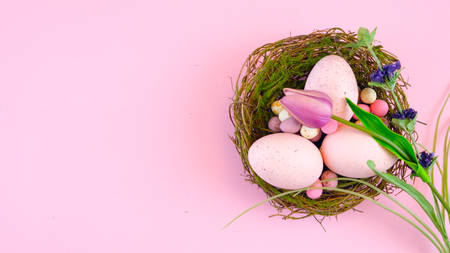 Happy Easter overhead with Easter eggs and decorations on a wood table background with copy space.の写真素材