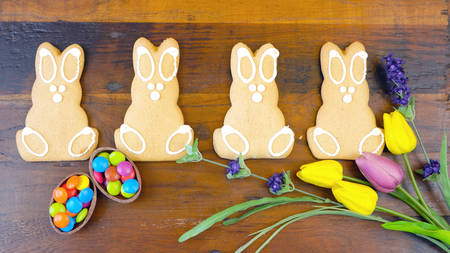 Happy Easter overhead with Easter Bunny cookies and decorations on a wood table backgroundの写真素材