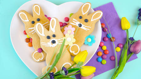 Happy Easter overhead with Easter Bunny cookies and decorations on a wood table backgroundの写真素材