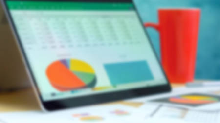 Blurred background with modern touch screen laptop for business, technology and finance concept.の写真素材